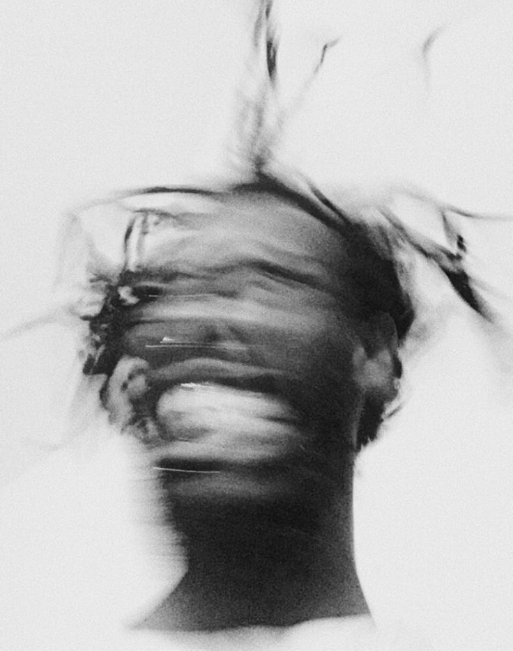 A face caught turning, motion blurred