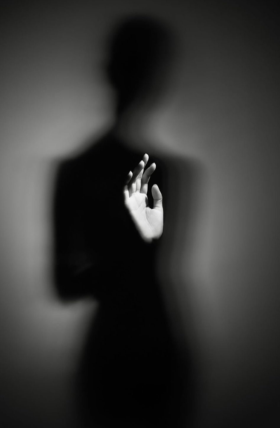 Silhouette with hand reaching into light
