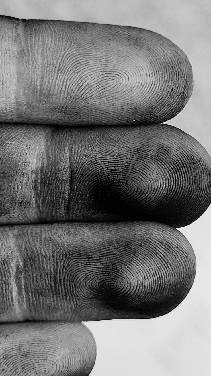 Macro of fingertips with developer-stained prints